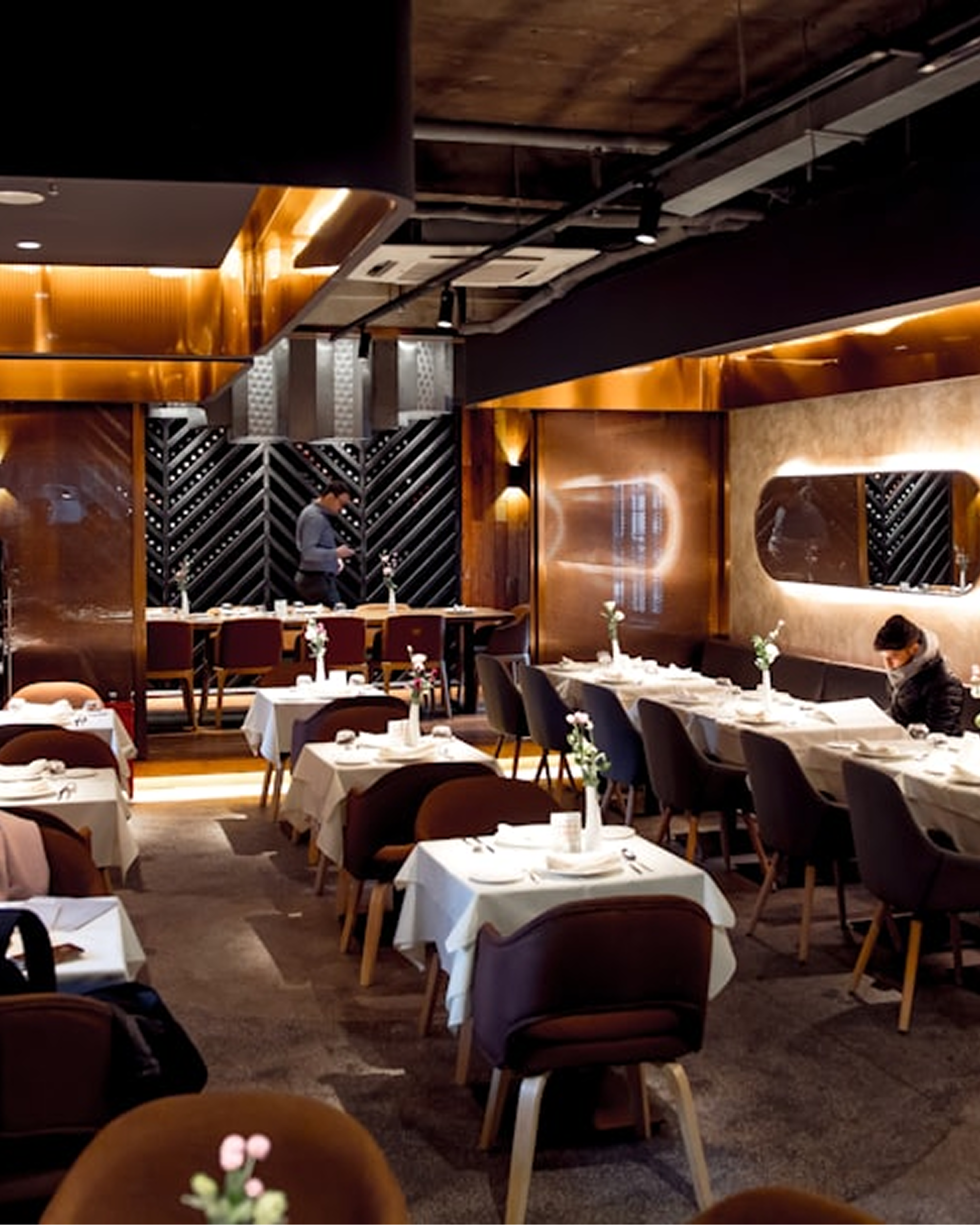 Elegant restaurant dining room framed by a golden glow
